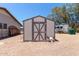Exterior view of shed with decorative skull, offering ample storage space at 7730 E Culver St, Mesa, AZ 85207