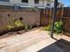 Cozy backyard featuring a brick-paved patio, lush plants, wooden fence, and block wall at 7801 N 44Th Dr # 1036, Glendale, AZ 85301