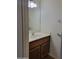 Cozy half-bathroom featuring a white vanity with a modern light fixture at 7801 N 44Th Dr # 1036, Glendale, AZ 85301