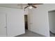View of the bedroom showing a ceiling fan, closet, and access to another room at 7801 N 44Th Dr # 1036, Glendale, AZ 85301