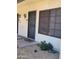 Close-up of a townhouse door with security bars and vintage sconce lighting at 7801 N 44Th Dr # 1036, Glendale, AZ 85301