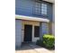 Townhouse entrance featuring a gray-trimmed door and tidy landscaping at 7801 N 44Th Dr # 1036, Glendale, AZ 85301