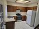 A full view of the kitchen with wood cabinets, stainless steel appliances, and tiled floors at 7801 N 44Th Dr # 1036, Glendale, AZ 85301