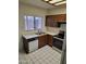 A full view of the kitchen with wood cabinets, stainless steel appliances, and tiled floors at 7801 N 44Th Dr # 1036, Glendale, AZ 85301