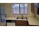 This kitchen features a window over the sink with wood cabinets and tiled floors at 7801 N 44Th Dr # 1036, Glendale, AZ 85301