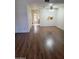 Open living room featuring warm wood flooring, ceiling fan, and bright natural light at 7801 N 44Th Dr # 1036, Glendale, AZ 85301