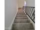 Carpeted staircase with black railing at 7801 N 44Th Dr # 1036, Glendale, AZ 85301