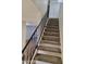 A view of the stairs with black railing that goes to the upper floor of the home at 7801 N 44Th Dr # 1036, Glendale, AZ 85301