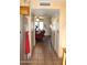 Hallway featuring tile flooring, connecting to the living area with natural light, and closet space at 7977 W Wacker Rd # 196, Peoria, AZ 85381