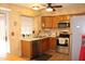Traditional kitchen featuring stainless steel appliances, wood cabinets, and neutral countertops at 7977 W Wacker Rd # 196, Peoria, AZ 85381