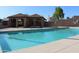 Community pool area featuring inviting clear water, a covered pavilion, and well-maintained grounds at 7977 W Wacker Rd # 196, Peoria, AZ 85381