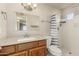 Bright bathroom featuring a shower with striped curtain and a vanity with a mirror at 840 N Acacia --, Mesa, AZ 85213