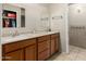 Bathroom featuring double sinks and vanities, mirrors and tan tiled floors at 840 N Acacia --, Mesa, AZ 85213