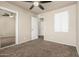 Bedroom with tan walls, carpet flooring, and a ceiling fan and mirrored closet at 840 N Acacia --, Mesa, AZ 85213