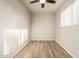 Empty bedroom features vinyl floors, a ceiling fan, and a window with blinds at 840 N Acacia --, Mesa, AZ 85213