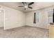 Neutral bedroom with a ceiling fan, carpet and two windows providing natural light at 840 N Acacia --, Mesa, AZ 85213