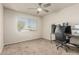 Bedroom with carpet flooring, ceiling fan, desk, and a large window at 840 N Acacia --, Mesa, AZ 85213