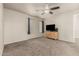 Spacious bedroom with a ceiling fan, carpet and dresser with television on top at 840 N Acacia --, Mesa, AZ 85213
