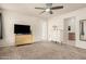 Large bedroom featuring neutral carpet, ceiling fan, dresser, and television at 840 N Acacia --, Mesa, AZ 85213