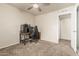 Bedroom with carpet flooring, ceiling fan, desk, and a black chair at 840 N Acacia --, Mesa, AZ 85213