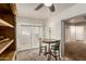 Cozy breakfast nook featuring two barstools, a round table, and lots of natural light via glass doors to the backyard at 840 N Acacia --, Mesa, AZ 85213