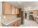 Updated kitchen with stainless steel appliances, quartz countertops, tile backsplash and tile flooring at 840 N Acacia --, Mesa, AZ 85213
