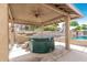 Covered patio featuring a hot tub, built in barbeque and ceiling fan at 840 N Acacia --, Mesa, AZ 85213