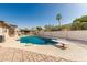 Backyard pool with diving board, covered patio, privacy wall, and desert landscaping at 840 N Acacia --, Mesa, AZ 85213