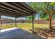Covered patio overlooks a large backyard with mature trees at 845 E Hampton Ave, Mesa, AZ 85204