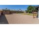 View of a large backyard area, mature trees, and block fence at 845 E Hampton Ave, Mesa, AZ 85204