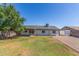 Spacious yard with mature trees and an empty lot at 845 E Hampton Ave, Mesa, AZ 85204