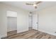 A small bedroom with a neutral palette, laminated flooring, and a closet at 845 E Hampton Ave, Mesa, AZ 85204