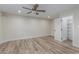 Bright bedroom with wood floors, walk-in closet, and ceiling fan at 845 E Hampton Ave, Mesa, AZ 85204