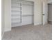 Cozy bedroom with carpet and a bright closet with shelves and wooden rods for hanging items at 845 E Hampton Ave, Mesa, AZ 85204