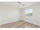 A small bedroom with a neutral palette, laminated flooring, and natural light from a window at 845 E Hampton Ave, Mesa, AZ 85204