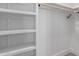 A very neat closet with white walls, a shelf and a wooden rod for hanging items at 845 E Hampton Ave, Mesa, AZ 85204