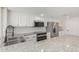 Modern kitchen with granite countertops, stainless appliances, and white cabinetry at 845 E Hampton Ave, Mesa, AZ 85204