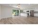 An open concept kitchen with stainless steel appliances and a sliding glass door to the back yard at 845 E Hampton Ave, Mesa, AZ 85204