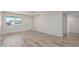 A cozy living room with wood-look floors, and a window with natural light at 845 E Hampton Ave, Mesa, AZ 85204