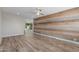 A cozy living room with wood-look floors and a wood-paneled wall at 845 E Hampton Ave, Mesa, AZ 85204