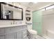 Bright bathroom with modern vanity, framed mirror, and glass-enclosed shower/tub at 8940 W Olive Ave # 59, Peoria, AZ 85345