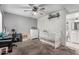 Bedroom with ceiling fan, grey paint, work desk, and a baby crib at 8940 W Olive Ave # 59, Peoria, AZ 85345