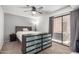 Cozy bedroom featuring a ceiling fan, dresser, and sliding door access to the patio at 8940 W Olive Ave # 59, Peoria, AZ 85345