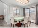 Bright dining room features natural light, a stylish light fixture, and a seamless transition to outdoor living at 8940 W Olive Ave # 59, Peoria, AZ 85345