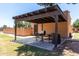 Community barbeque with pergola, grill, small prep table and barbeque utensils at 8940 W Olive Ave # 59, Peoria, AZ 85345