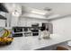 Bright kitchen featuring white cabinetry, stainless steel appliances, and a spacious breakfast bar at 8940 W Olive Ave # 59, Peoria, AZ 85345