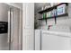 Convenient laundry area near the kitchen featuring stainless steel appliances and extra storage shelving at 8940 W Olive Ave # 59, Peoria, AZ 85345