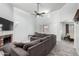 Bright living room featuring a ceiling fan, brick fireplace, and seamless transition to the dining area at 8940 W Olive Ave # 59, Peoria, AZ 85345