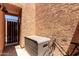 Enclosed patio featuring textured walls, a storage box, and a vintage bicycle at 8940 W Olive Ave # 59, Peoria, AZ 85345