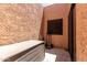 Enclosed patio with textured walls, a storage box, and a utility dolly at 8940 W Olive Ave # 59, Peoria, AZ 85345